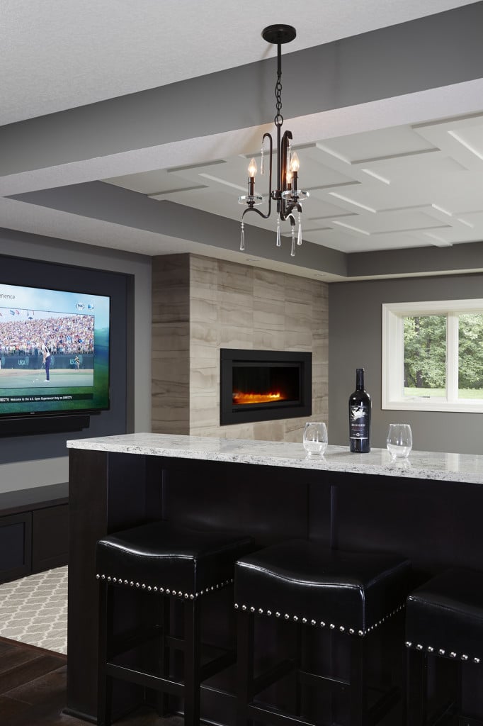 This design (by R|House Design Build) added a built-in elevated drink ledge that increased seating options and helped to define the TV feature wall area / Source