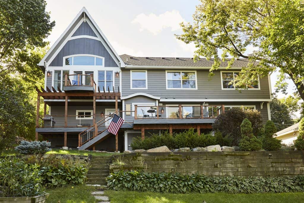 Focusing on the lakefront, this addition incorporated a new balcony for the owners to use every day. You can see the master suite addition at the peak on the left.