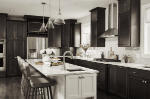 Rich, dark kitchen cabinets against a light backsplash and walls made for a sophisticated kitchen style in this home.