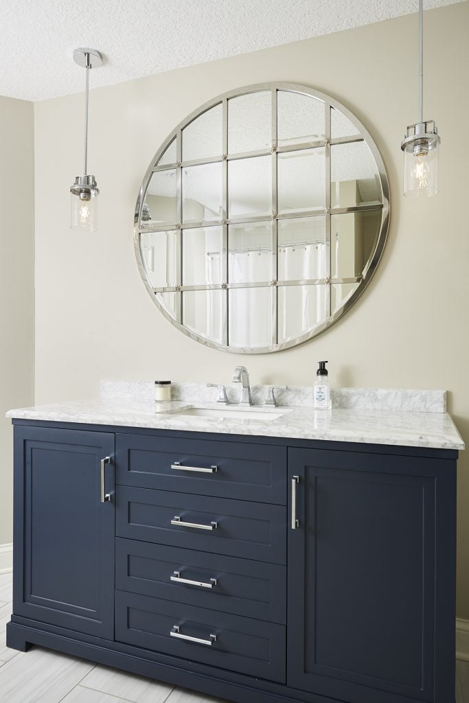 Round Mirror over Navy Blue Vanity with Pendant Lights