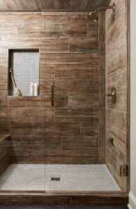 Steam Shower, Wood Look Tile Planks, Penny Round Tile, Champagne Brass Fixtures, Shampoo Shelf Niche, Shower Bench, Frameless glass shower door