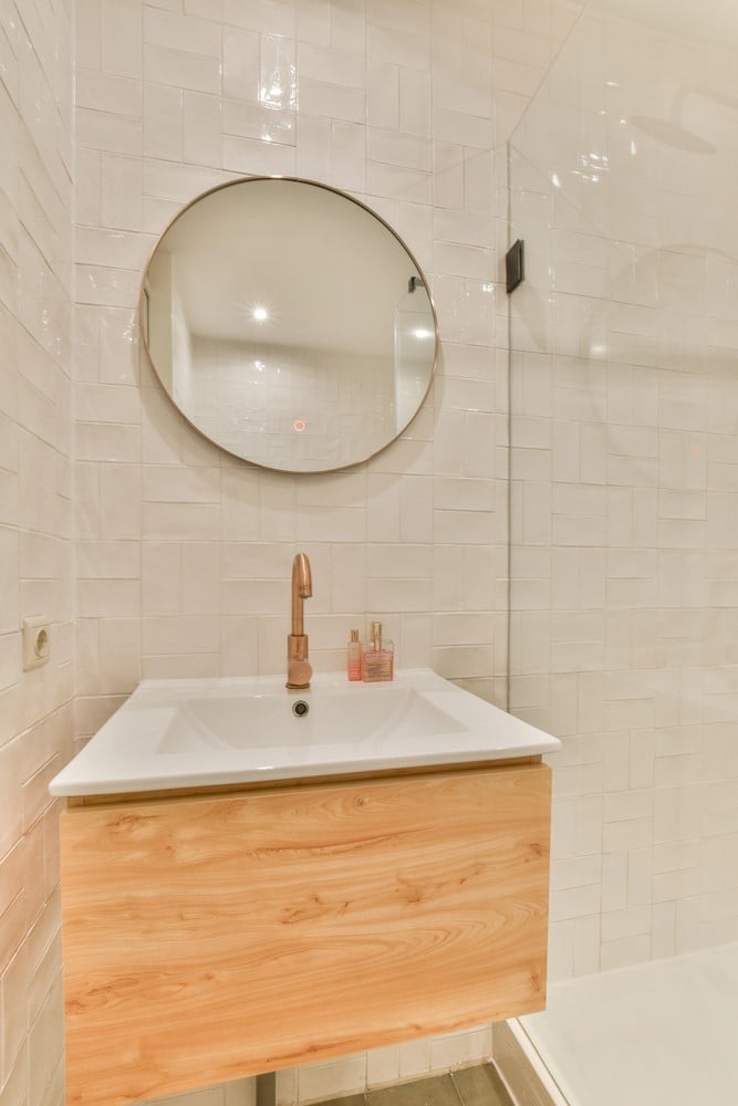 bathroom is wrapped in textured subway tile in a basket weave pattern creating a more spacious looking tile design idea