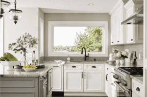 Beautiful oil-rubbed bronze contemporary hardware pulls are used throughout this kitchen, adding a touch of cohesiveness and class that is unmatched. (Interior Design: Carla Bast | Carla Bast Design)