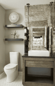 Mirrored subway tile works double duty as this bathroom’s mirror and backsplash, keeping things classic, yet simultaneously visually interesting. (Interior Design by Carla Bast | Carla Bast Design)