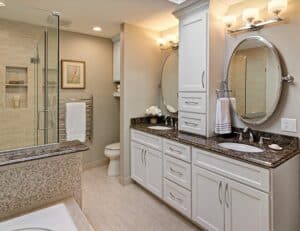 After a heft transformation, this master bath became a spa-like retreat for our clients, complete with extensive built-in storage solutions. Interior Design: Carla Bast | Carla Bast Design