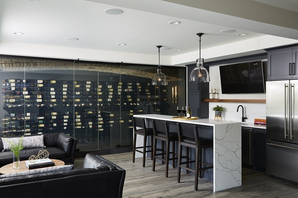 Spacious contemporary basement wet bar and wine cellar with Sherwin Williams Iron Ore and white color palette