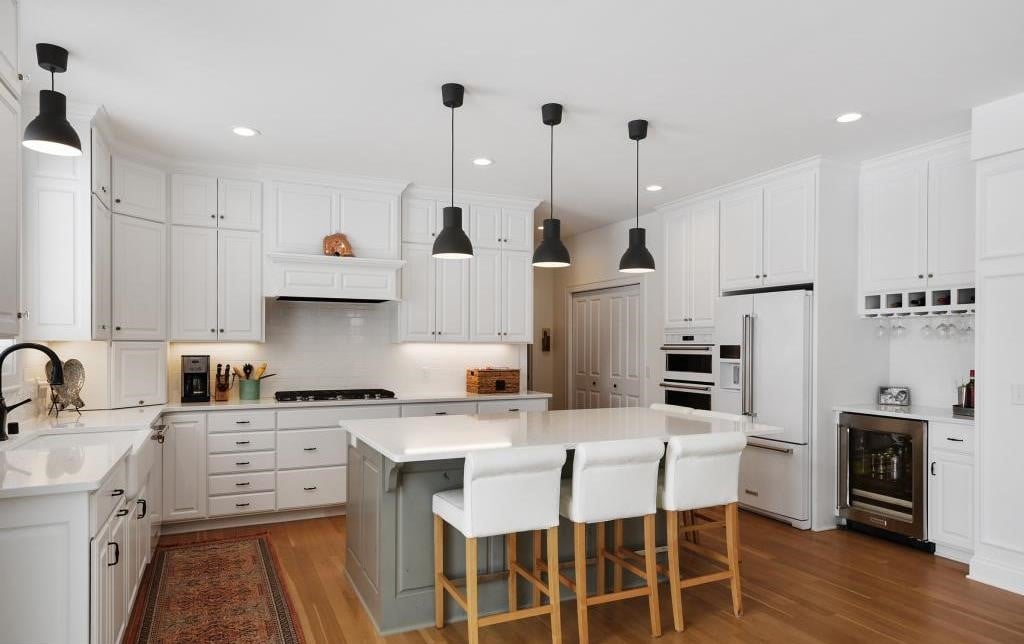 kitchen in high reflective white with web gray island