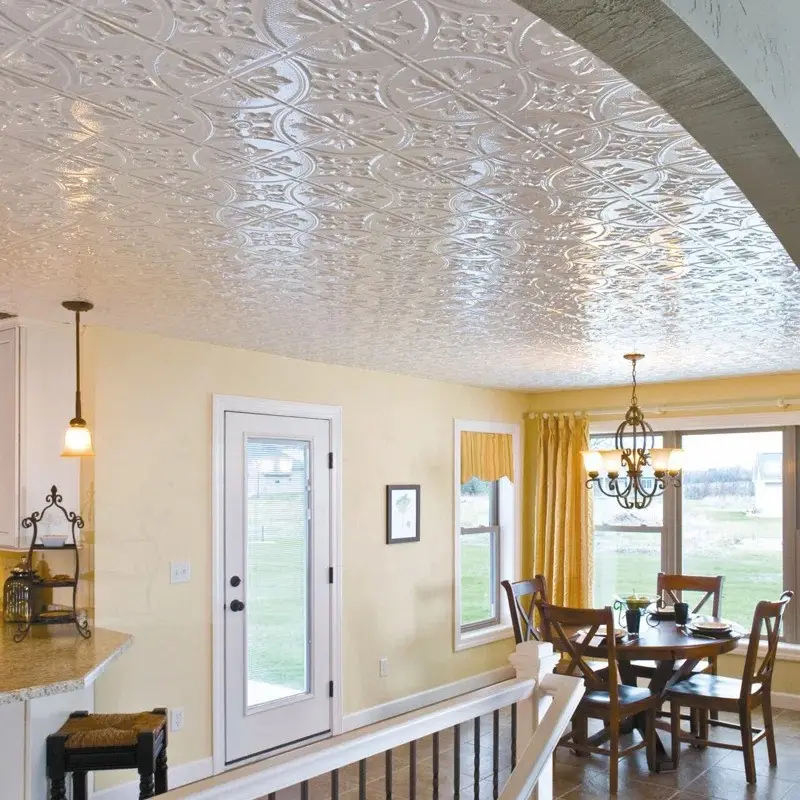 Glossy ceiling tiles reflect the light beautifully, making the ceiling appear higher in this dining space