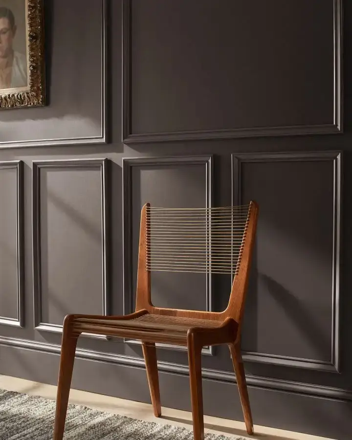 benjamin moore silhouette af-655 walls with molding and a warm wood accent chair
