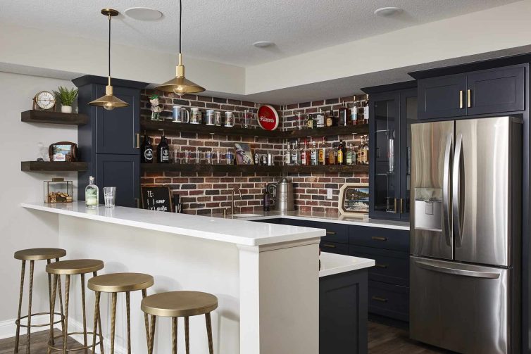 Navy blue bar cabinets with brass knobs and brick backsplash