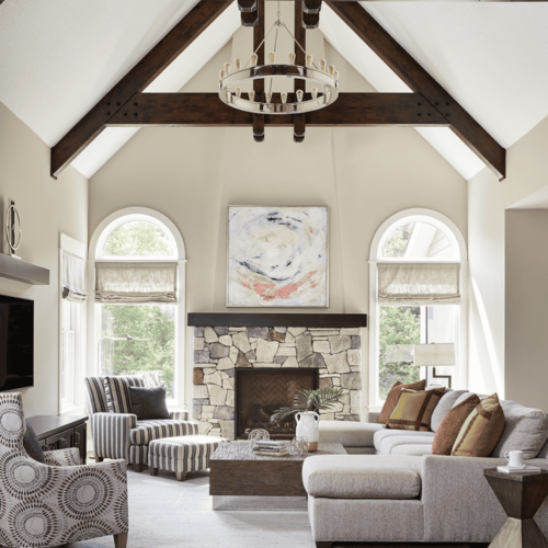 Greige paint on walls of family room with vaulted ceilings and wood beams