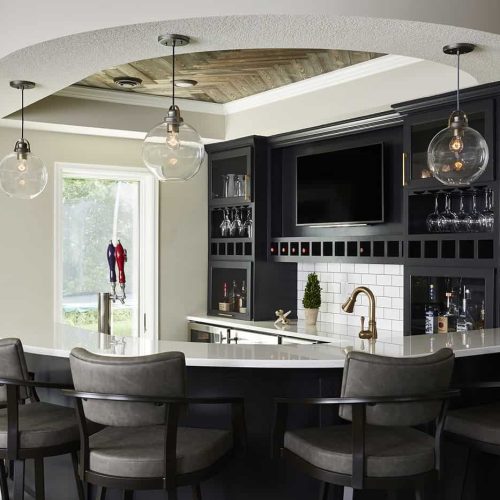 A curved bar adds architectural interest to this Minnesota finished basement.